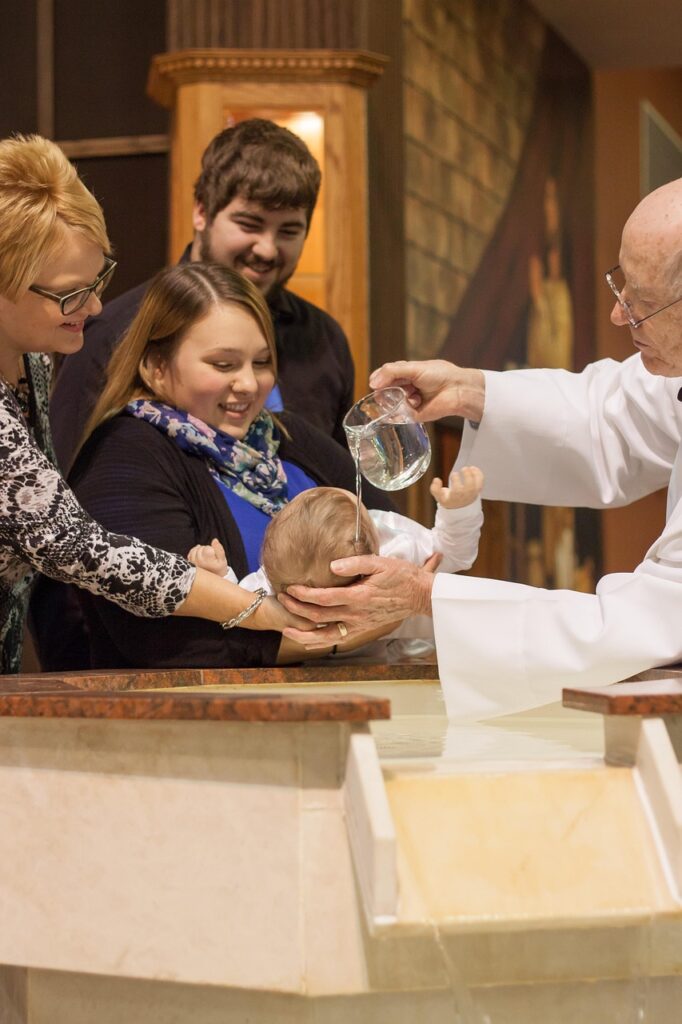 Baby being baptised by a Catholic priest
