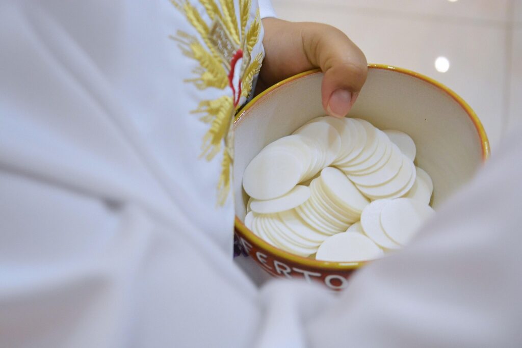 Priest holding a ciborium filled with hosts